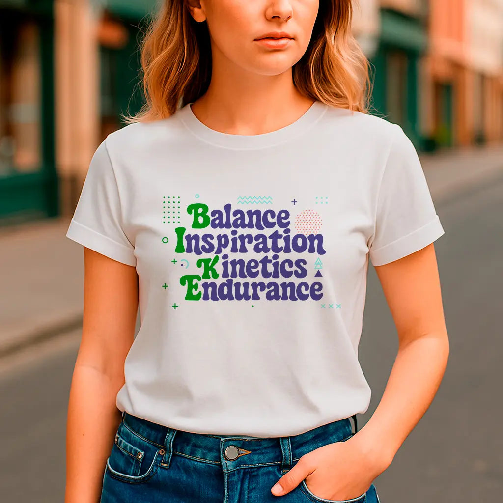 White t-shirt with colorful motivational typography text “Balance Inspiration Kinetics Endurance”
